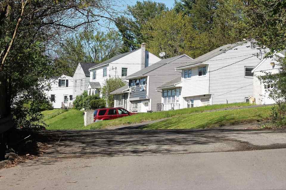 A street of single family rental houses on a clear afternoon