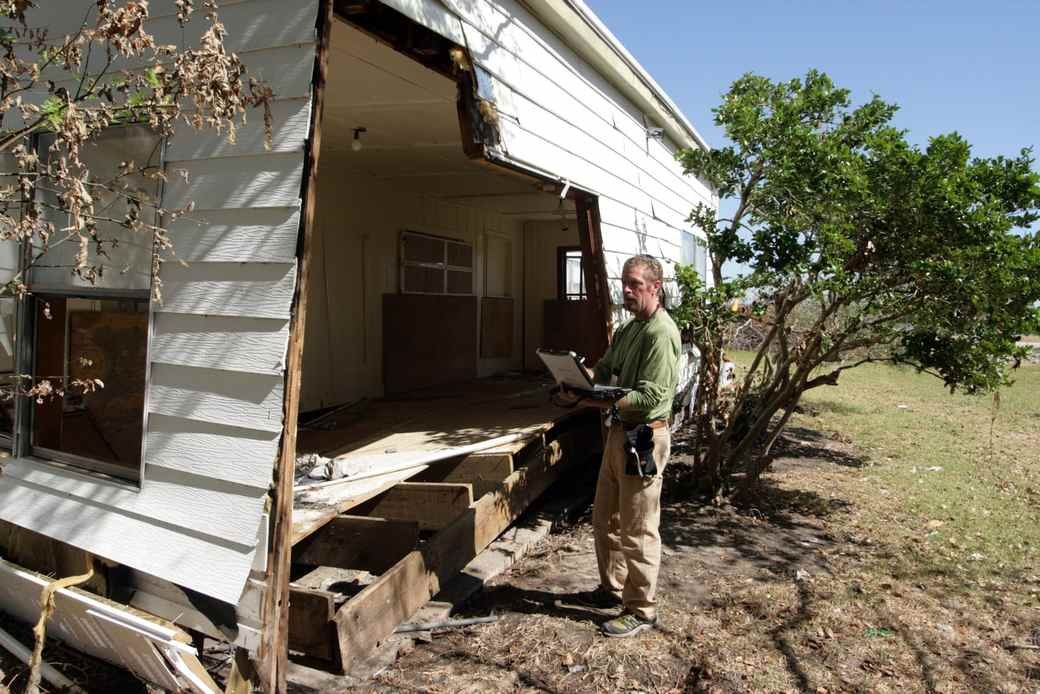 An inspector photographing a room on a tablet during a move out condition report