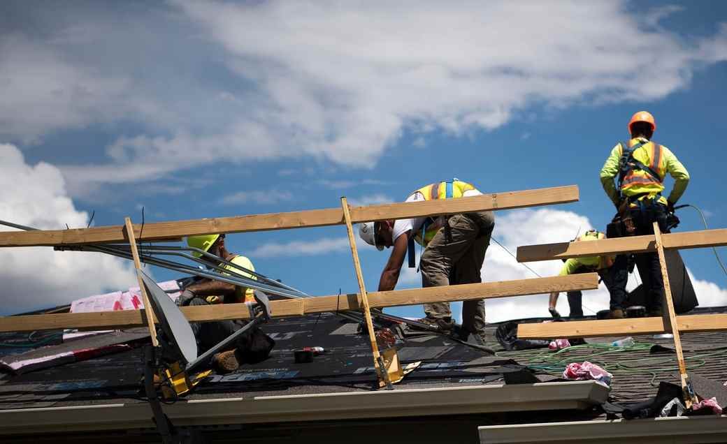 A roofing crew working on a residential roof